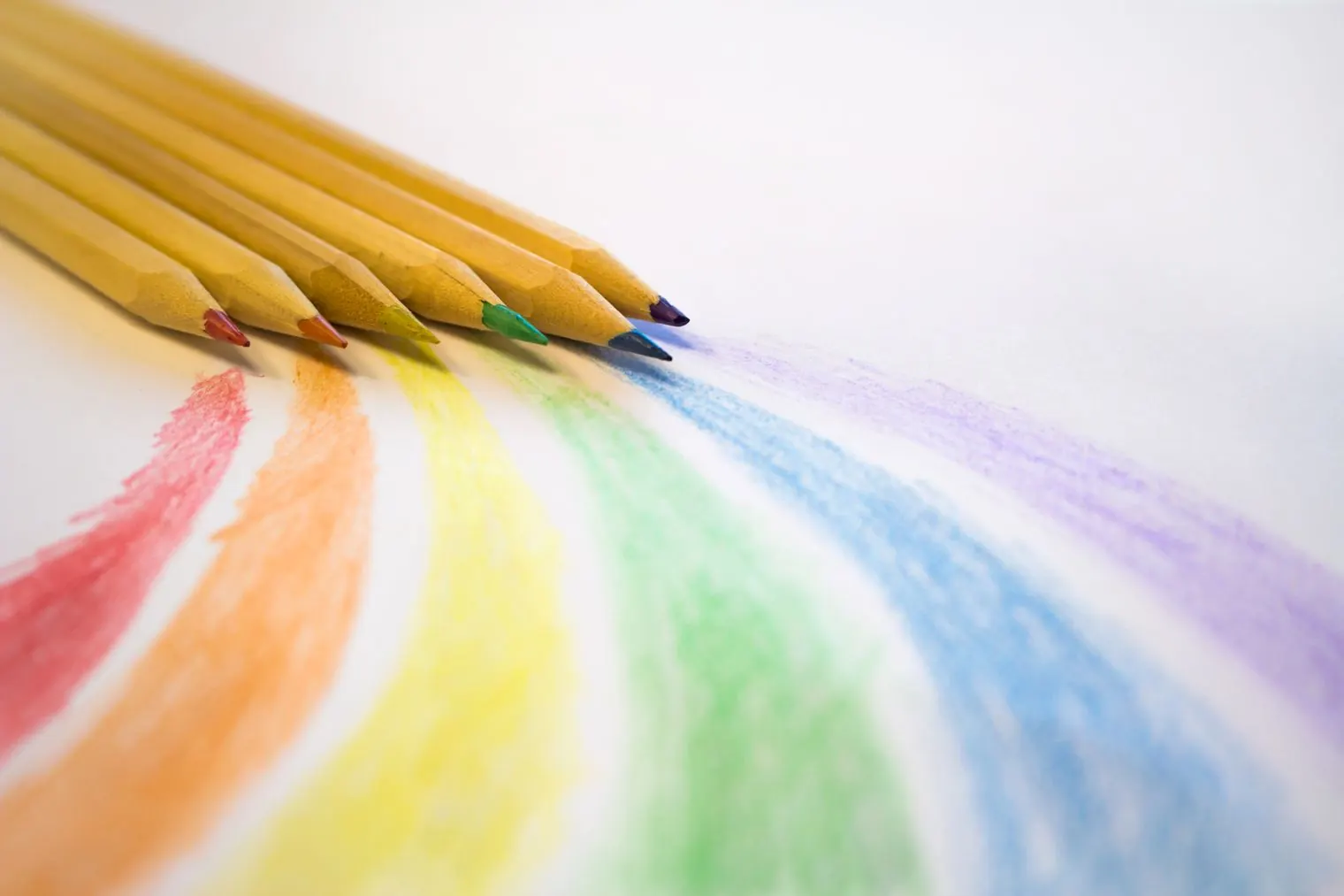 Colored pencils and the rainbow of strokes they drew on paper